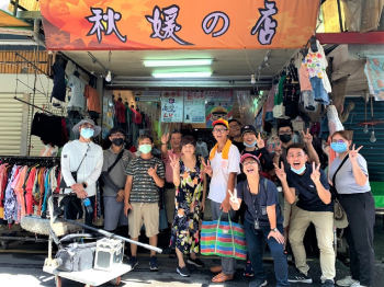 青年開心於宜蘭菜市場中經營超過40年、同時也是團隊成員方子維的家「秋媛的店」合影,透過市場導覽的過程中,認識宜蘭在地故事。.png