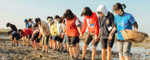 嘉義布袋壯遊點—青年在鹽田踩漿混土,為曬鹽做準備