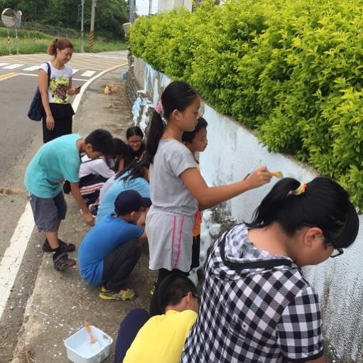 青年團隊與新城國小孩童共同將客家諺語彩繪至社區牆面